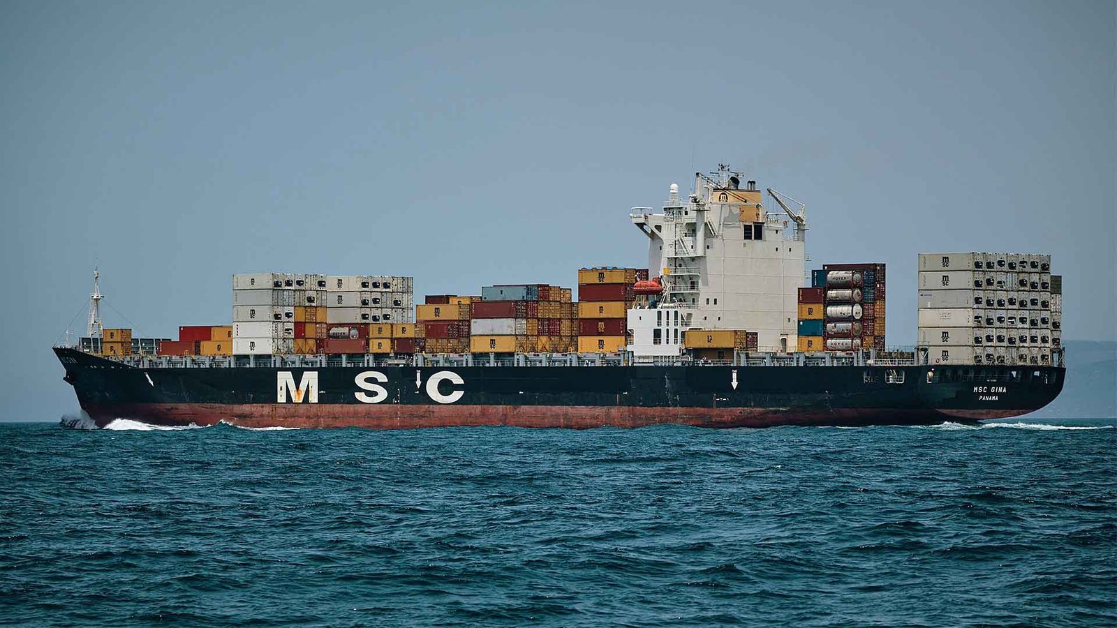 Cargo ship carrying containers across the ocean